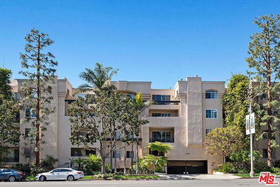 Front view of a multi-story residential building with balconies.