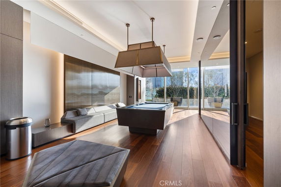 Indoor recreation room with a pool table and seating area.