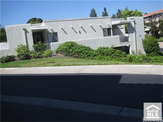 Front view of a modern multi-story building with balconies.