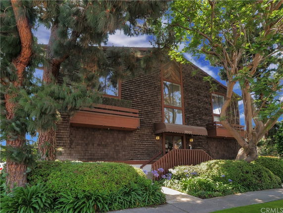 Front view of a two-story building with large windows and a shingle exterior.
