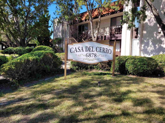Front view of a residential building with a sign reading 'Casa del Cerro 6878'.