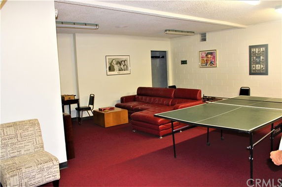 Indoor recreation area with table tennis and lounge seating.