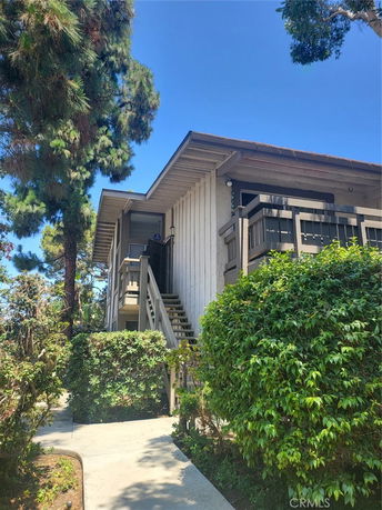 Front view of a two-story house with an exterior staircase.