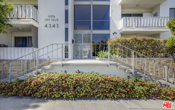 Front elevation of a multi-story building with balconies.