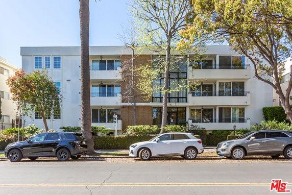 Front view of a multi-story residential building with balconies.