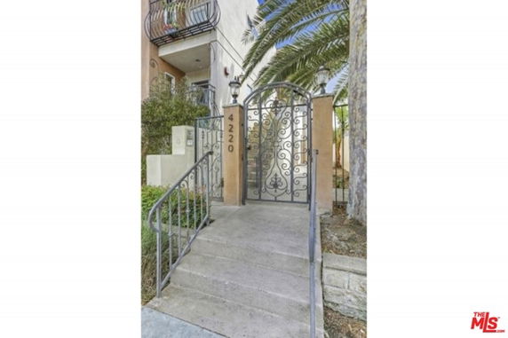 Front view of a building entrance with decorative wrought iron gate.