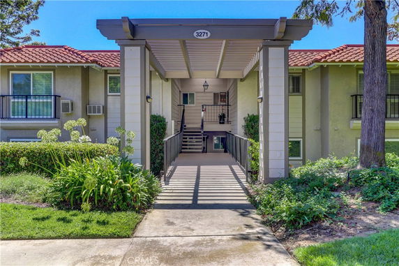 Front view of a residential building with a covered entrance walkway.