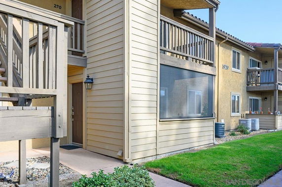 Front view of a multi-unit building with stairways and balconies.