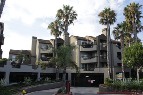 Front view of a multi-story apartment building with balconies.