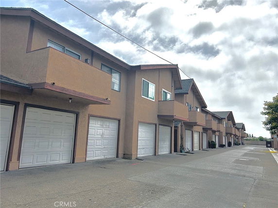 Front view of a row of two-story townhouses with garages.