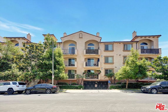 Front view of a multi-story apartment building with balconies.