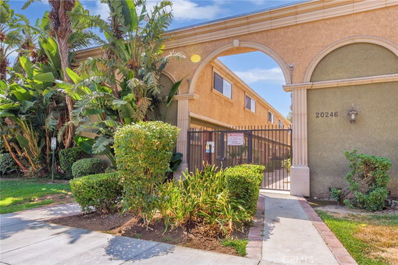 Entrance view of a building with an archway and a security gate.