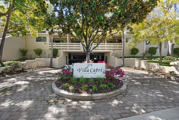 Front view of a building with a sign reading 'Villa Capri' in a landscaped area.