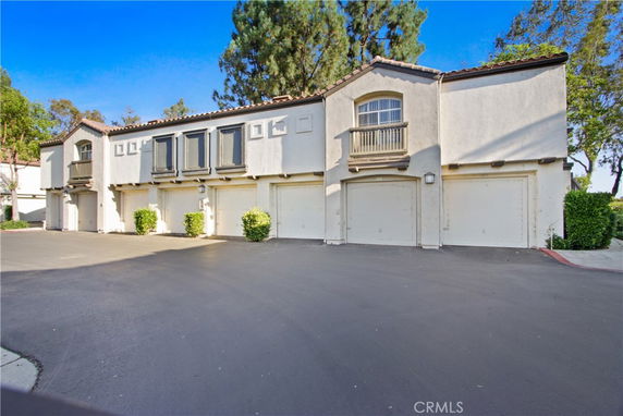 Front view of a multi-unit building with garages.