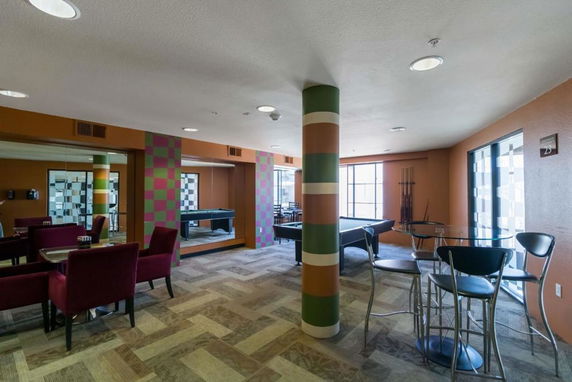 Indoor recreational area with pool table and seating.
