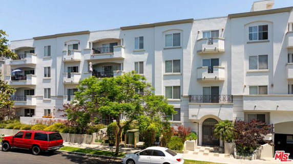 Front view of a multi-story residential building with balconies.