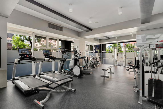 Indoor gym area with various fitness equipment, including treadmills and exercise machines.