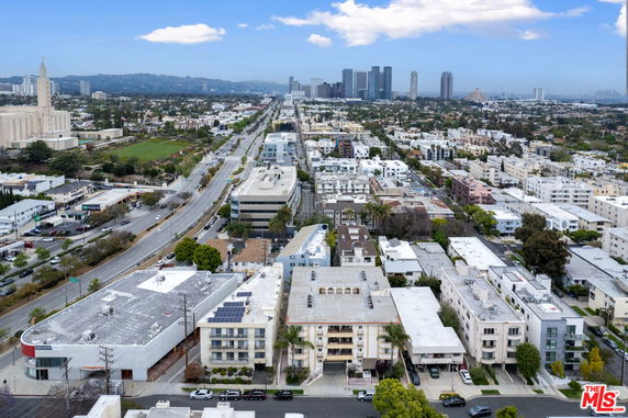Wide angle view of cityscape with numerous buildings and skyline in the distance.