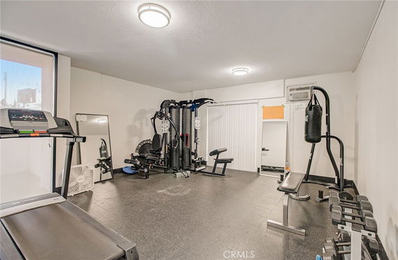 Indoor gym area with exercise equipment including treadmill, weight machine, and punching bag.