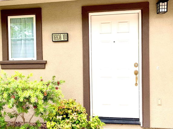 Front view of a house entrance with a white door and a window.