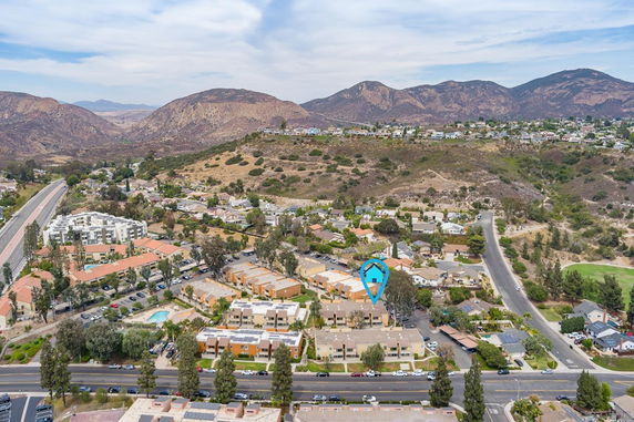 Aerial view of residential area with mountains in the background.