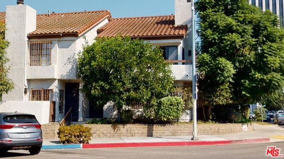 Front view of a two-story house with a tiled roof.