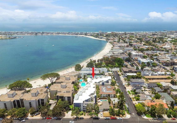 Aerial view of a coastal area with buildings and a beach.