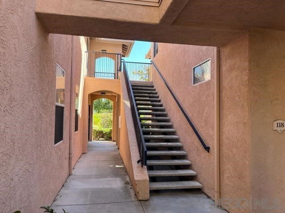 Outdoor stairway leading to the upper level of a multi-story building.
