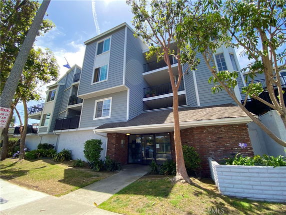 Front view of a multi-story residential building with balconies