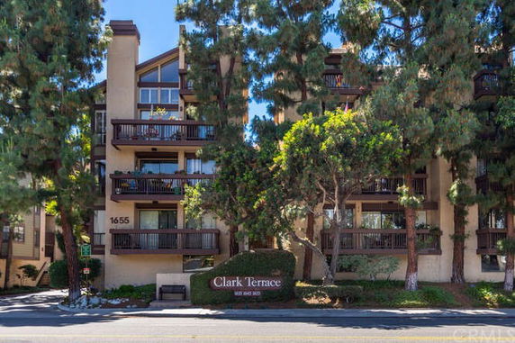Front view of a multi-story residential building with balconies.