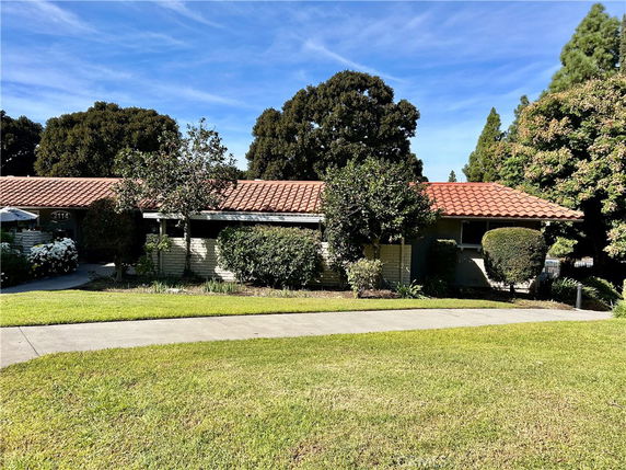 Front view of a single-story house with a red tile roof.