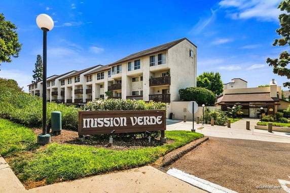 Front view of a multi-story residential building with balconies.