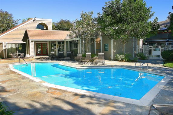 Outdoor swimming pool adjacent to a residential building.