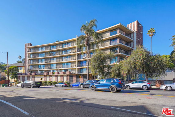Front view of a multi-story residential building with balconies.