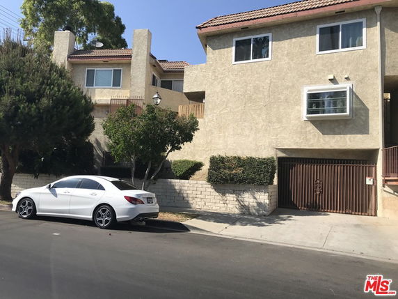 Front view of a two-story house with a garage.