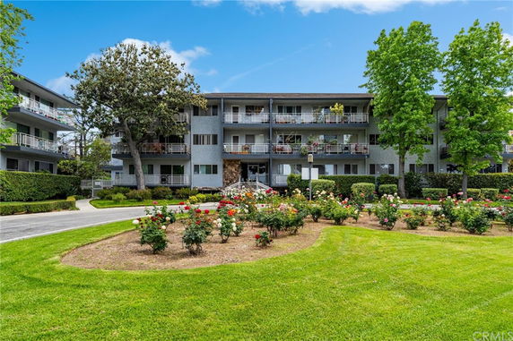 Front view of a multi-story residential building with balconies.