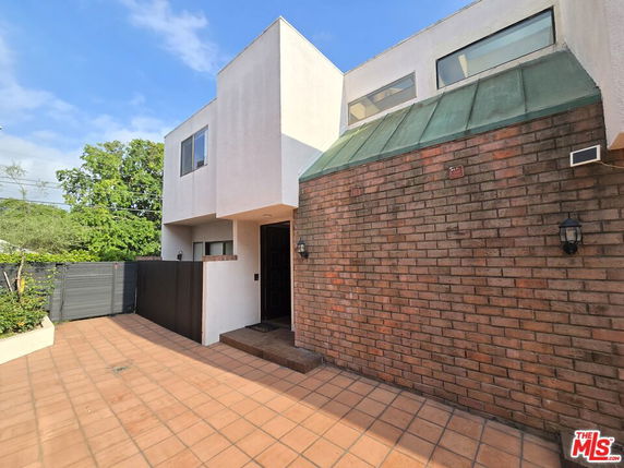 Front view of a modern two-story house with brick and stucco facade.