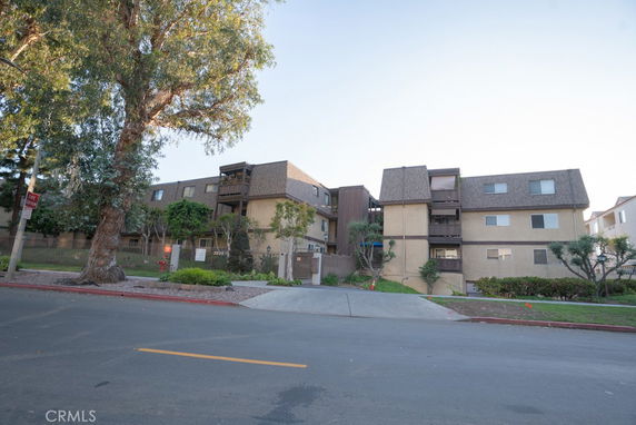 Front view of a multi-story residential building with balconies.