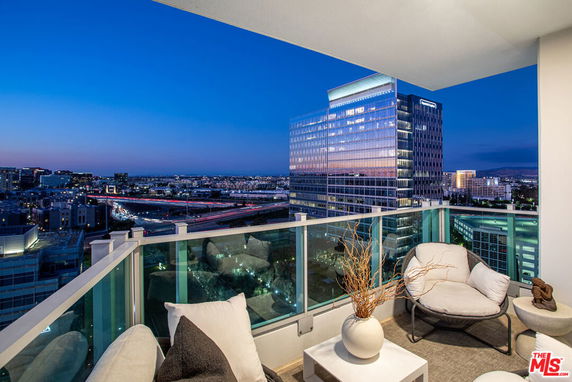 View from a balcony overlooking a cityscape at dusk.
