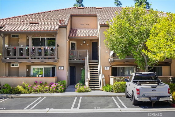 Front view of a two-story residential building with a central staircase and balconies.