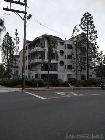 Front view of a multi-story residential building with balconies.