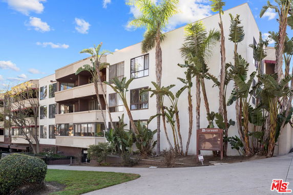 Front view of a multi-story apartment building with balconies.