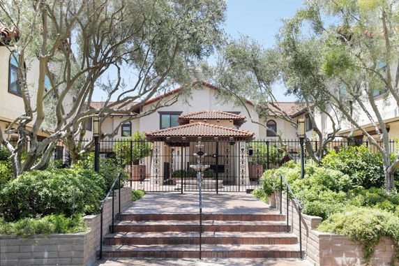 Front view of a house with a tiled roof and a gated entrance.