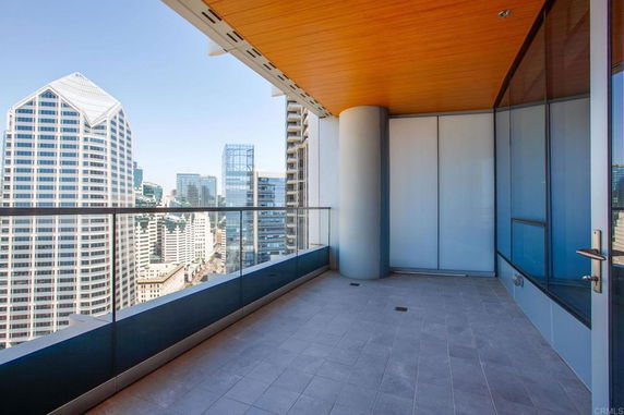 Balcony view overlooking a cityscape with modern high-rise buildings.