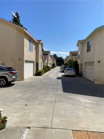 Row of two-story houses with garages and driveways