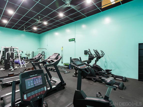 Interior view of a gym with exercise machines and equipment.