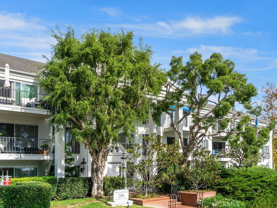 Front view of a multi-story residential building with balconies.