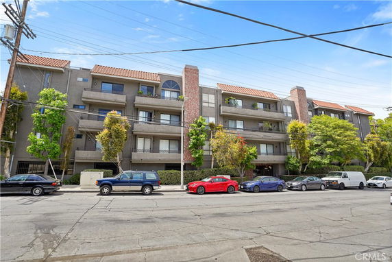 Front view of a multi-story residential building with balconies.