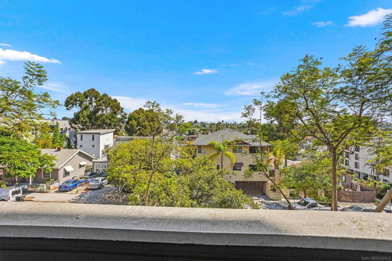View of residential area with trees and buildings.