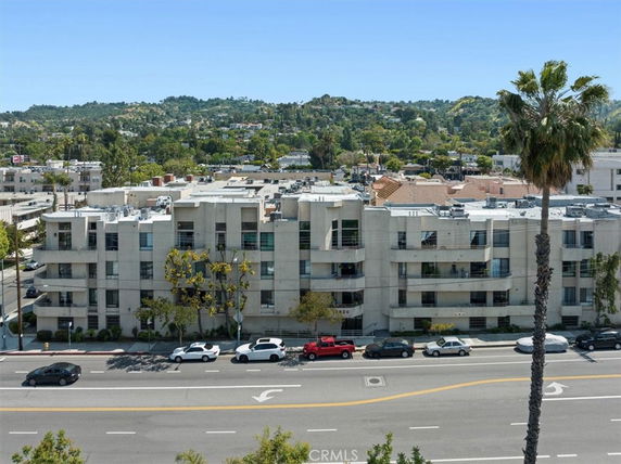 Front view of a multi-story residential building with balconies.